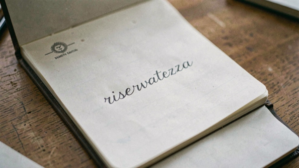 Busta aperta con una lettera stampata sopra un quaderno di appunti con la parola riservatezza scritta a mano in corsivo